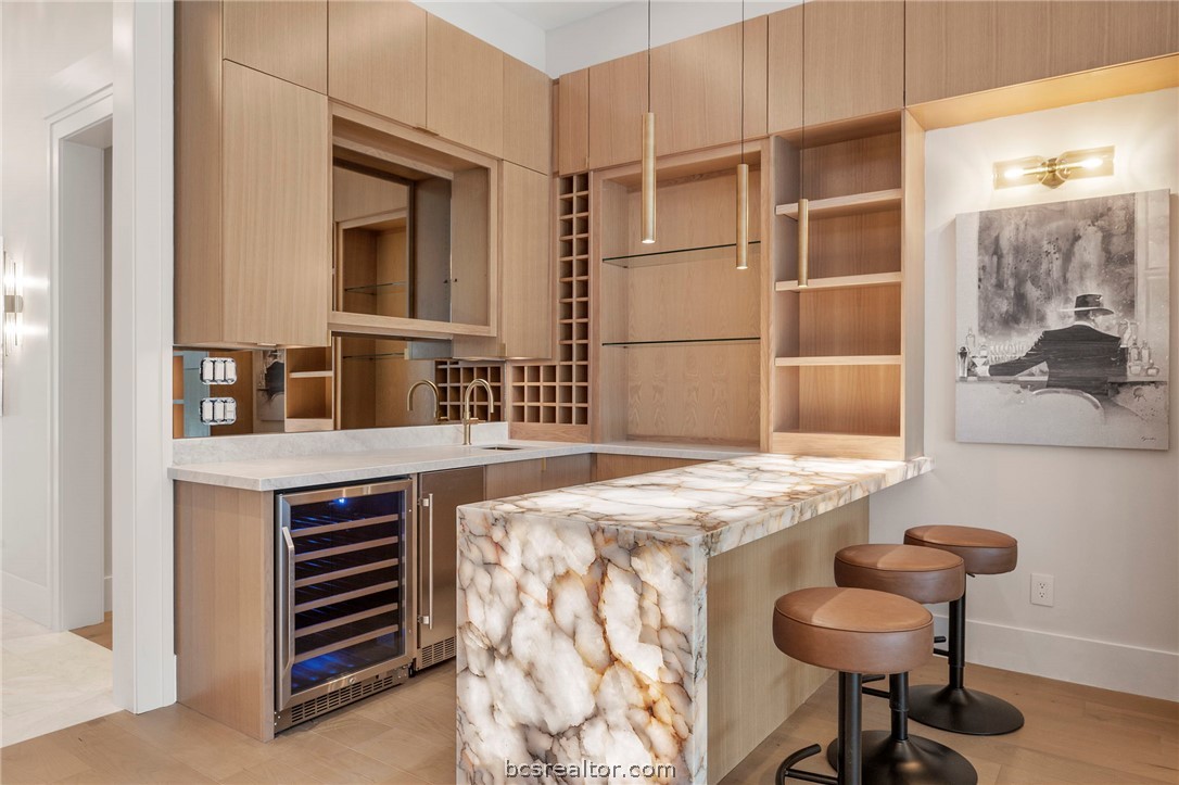 4212 Tuscany Court Bryan, TX 77802 - Photo 16 of 41 a kitchen with a sink cabinets and wooden floor