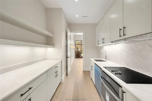 a bathroom with a granite countertop sink and a mirror with toilet
