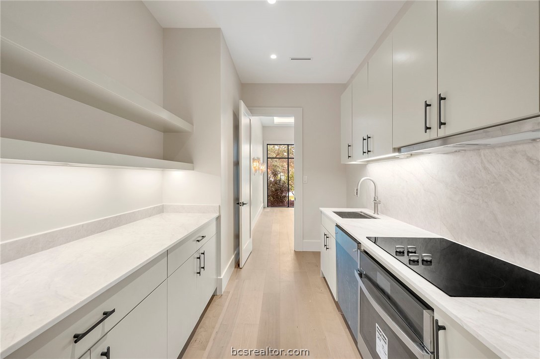 4212 Tuscany Court Bryan, TX 77802 - Photo 17 of 41 a kitchen with a sink stove and cabinets