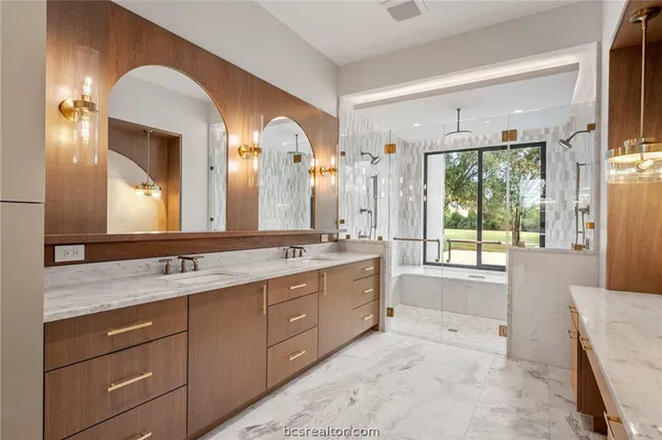 a spacious bathroom with a granite countertop sink and a mirror