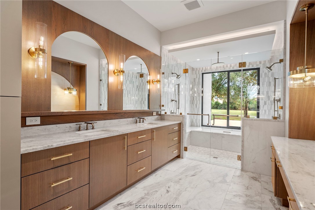 4212 Tuscany Court Bryan, TX 77802 - Photo 20 of 41 a spacious bathroom with a granite countertop sink mirror and a bathtub