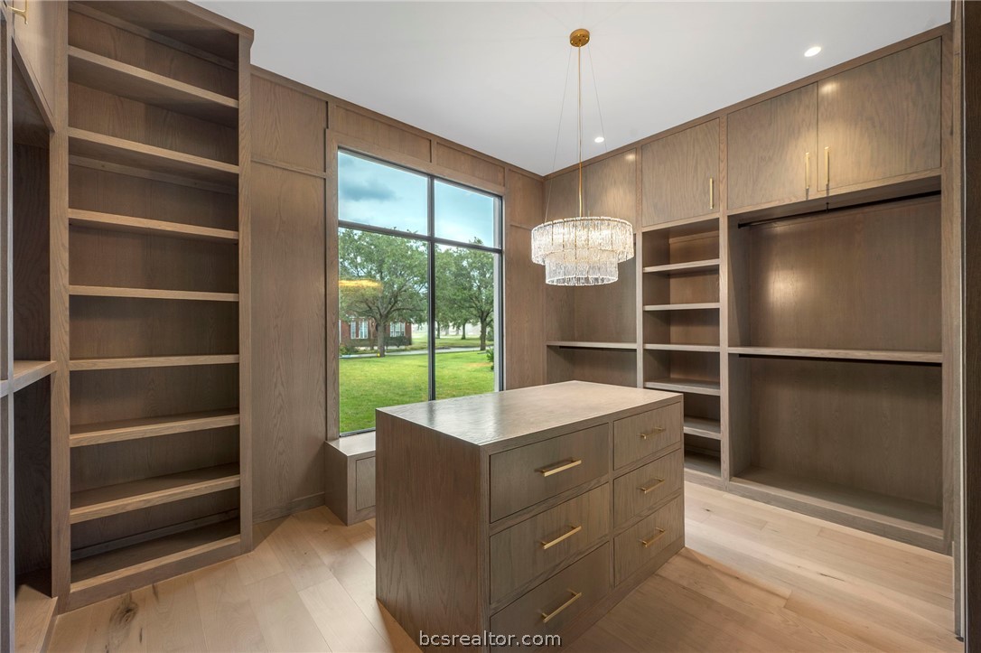 4212 Tuscany Court Bryan, TX 77802 - Photo 22 of 41 a room with cabinets and a ceiling fan