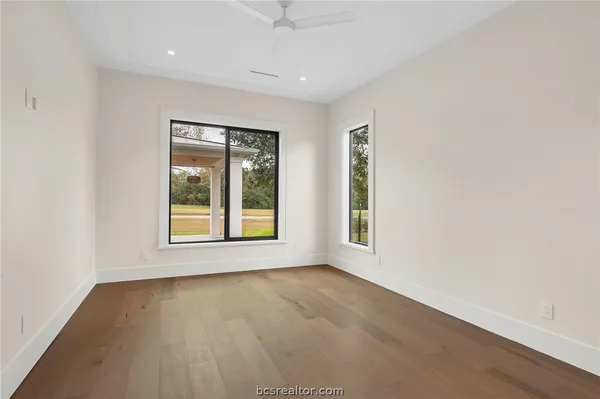 a bathroom with a granite countertop sink toilet a mirror a vanity and shower