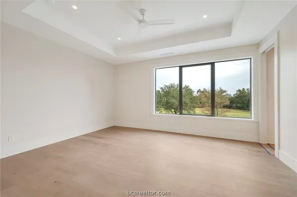 a bathroom with a granite countertop sink a toilet a mirror a bathtub and shower