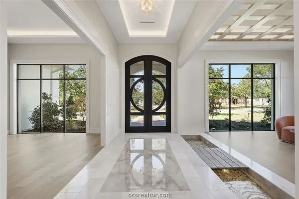 a lobby with furniture and window