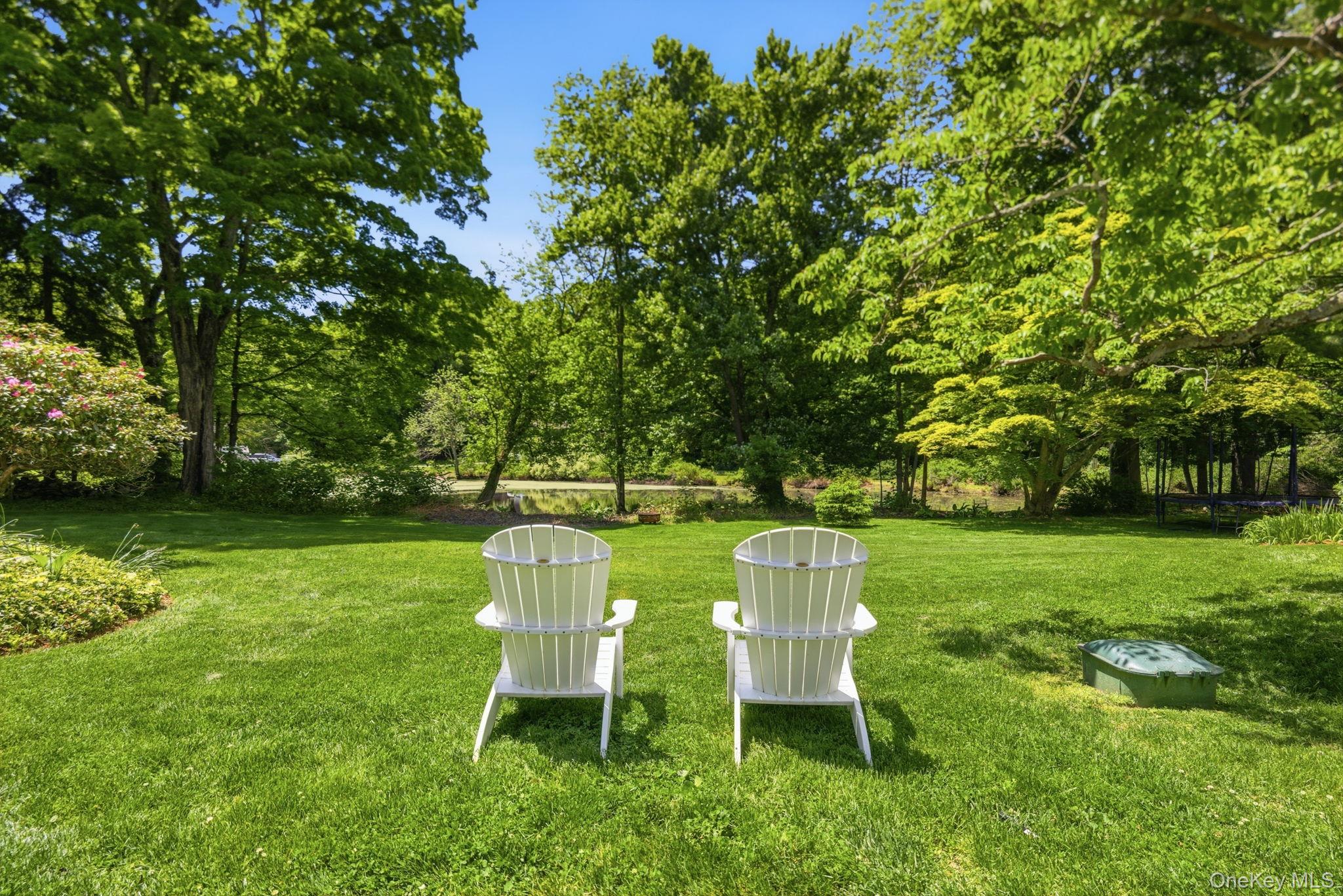 23 Pound Ridge Road Pound Ridge, NY 10576 - Photo 28 of 40 a view of a chair and table in the garden