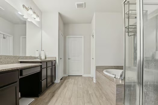 24714 Longwood Forest Drive Spring, TX 77373 - Photo 9 of 21 a bathroom with a granite countertop sink a toilet a mirror and shower