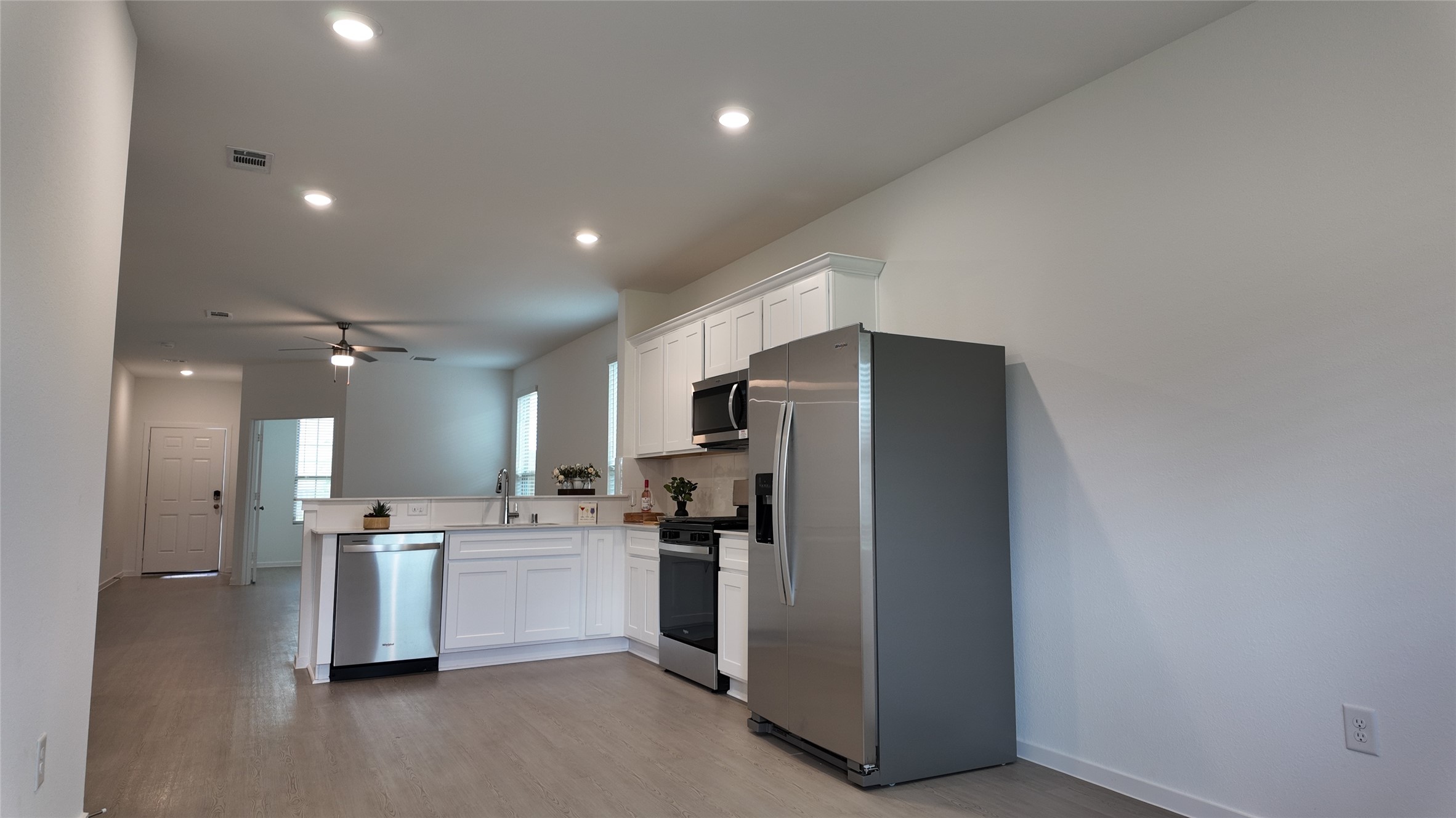 15023 Rustic Moon Road Conroe, TX 77302 - Photo 7 of 18 a kitchen with refrigerator and cabinets