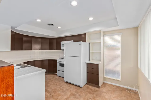 a view of kitchen and refrigerator