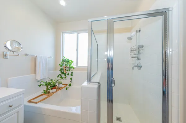 a kitchen with stainless steel appliances white cabinets a sink and wooden floor