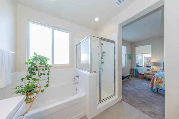 a kitchen with stainless steel appliances kitchen island granite countertop a stove top oven a sink a dining table and chairs with wooden floor