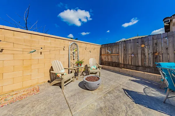 a view of a porch with furniture and a backyard