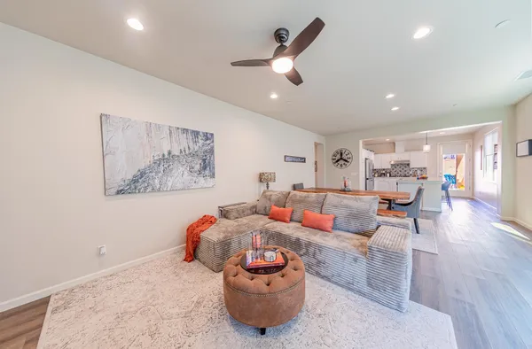 a living room with furniture and a chandelier