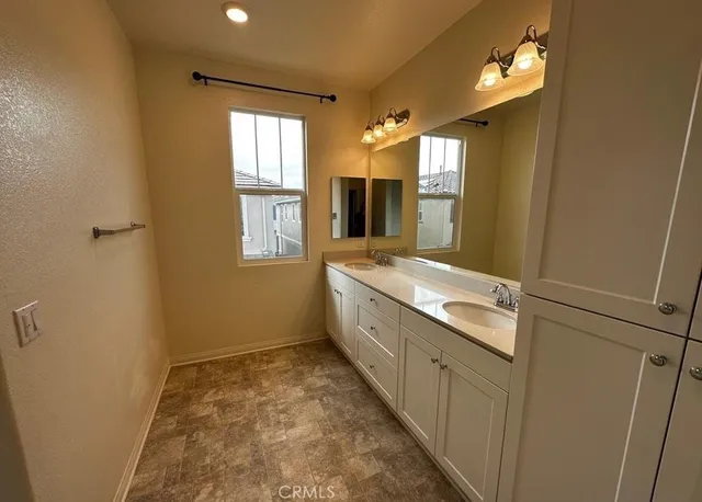 a bathroom with a sink a mirror and a bathtub