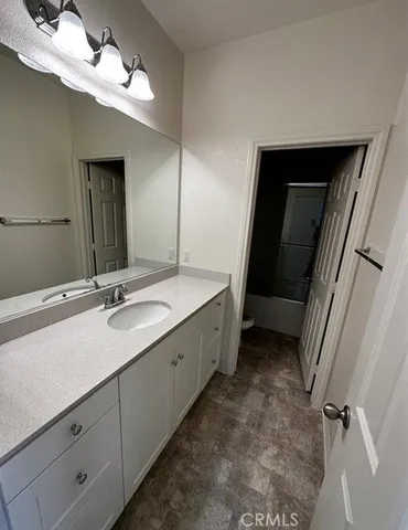 a bathroom with a double vanity sink and a mirror