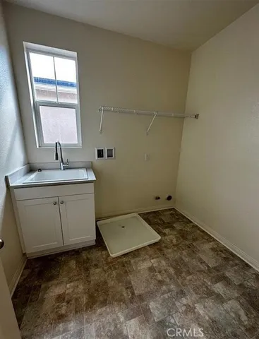 a bathroom with a sink toilet and window