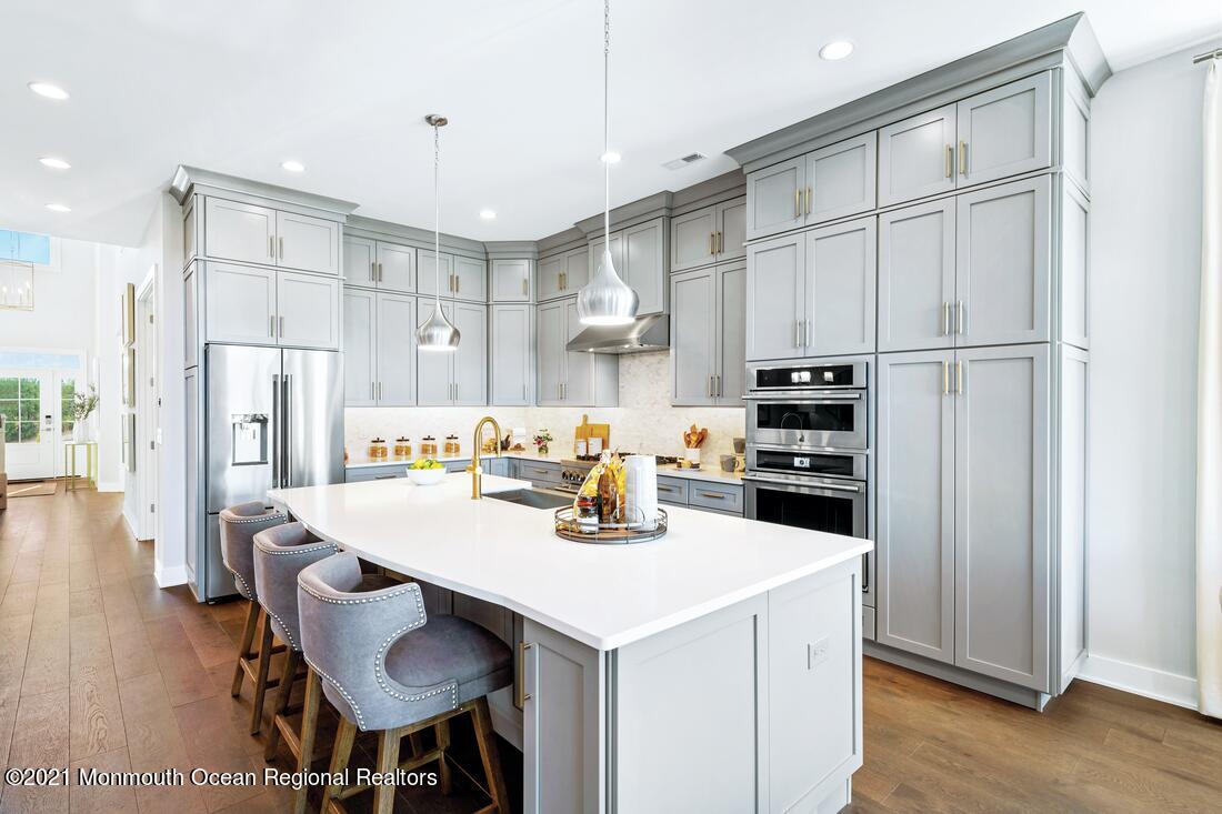 108 Sofia Drive Manalapan, NJ 07726 - Photo 2 of 9 a kitchen with stainless steel appliances a table chairs and a refrigerator