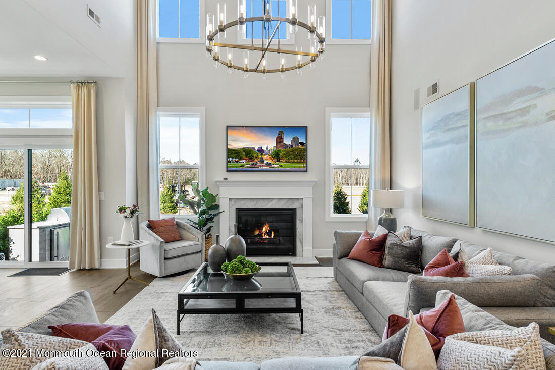 108 Sofia Drive Manalapan, NJ 07726 - Photo 3 of 9 a living room with furniture a fireplace and a flat screen tv