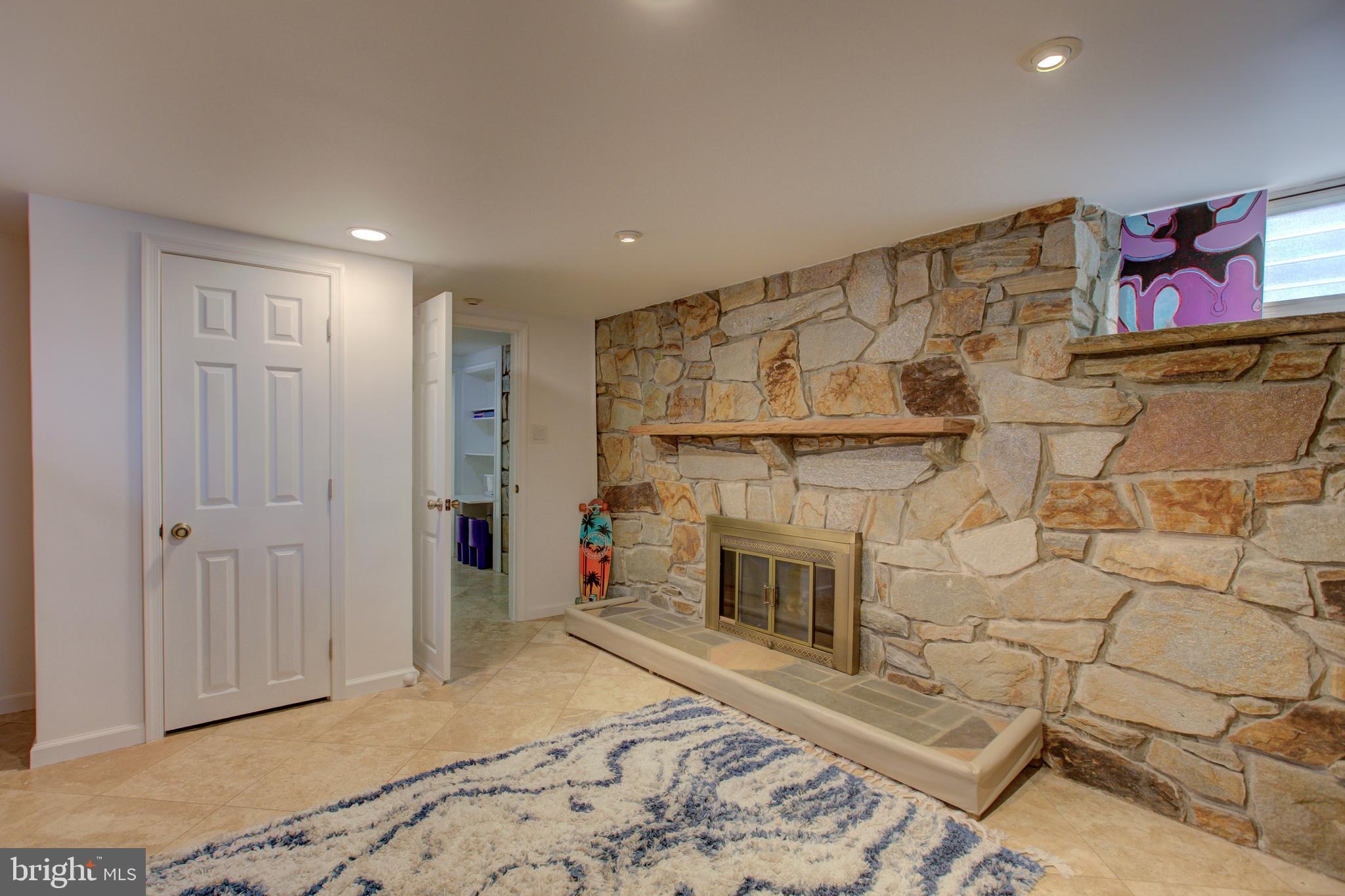 4119 Westview Road Baltimore, MD 21218 - Photo 34 of 51 Basement w/ wood burning FP & travertine flooring