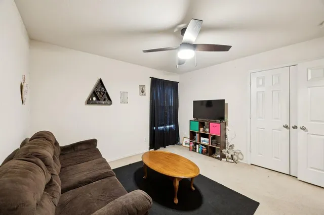 a spacious bedroom with a bed and a couch