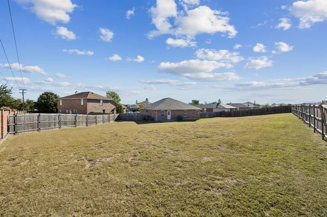 a front view of a house with a garden and yard