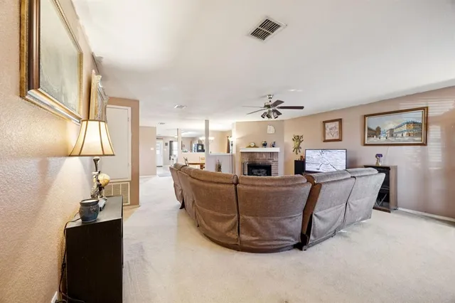 a living room with furniture a chandelier and a flat screen tv