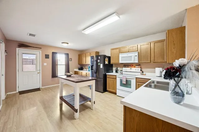 a kitchen with stainless steel appliances kitchen island granite countertop lots of counter top space and cabinets
