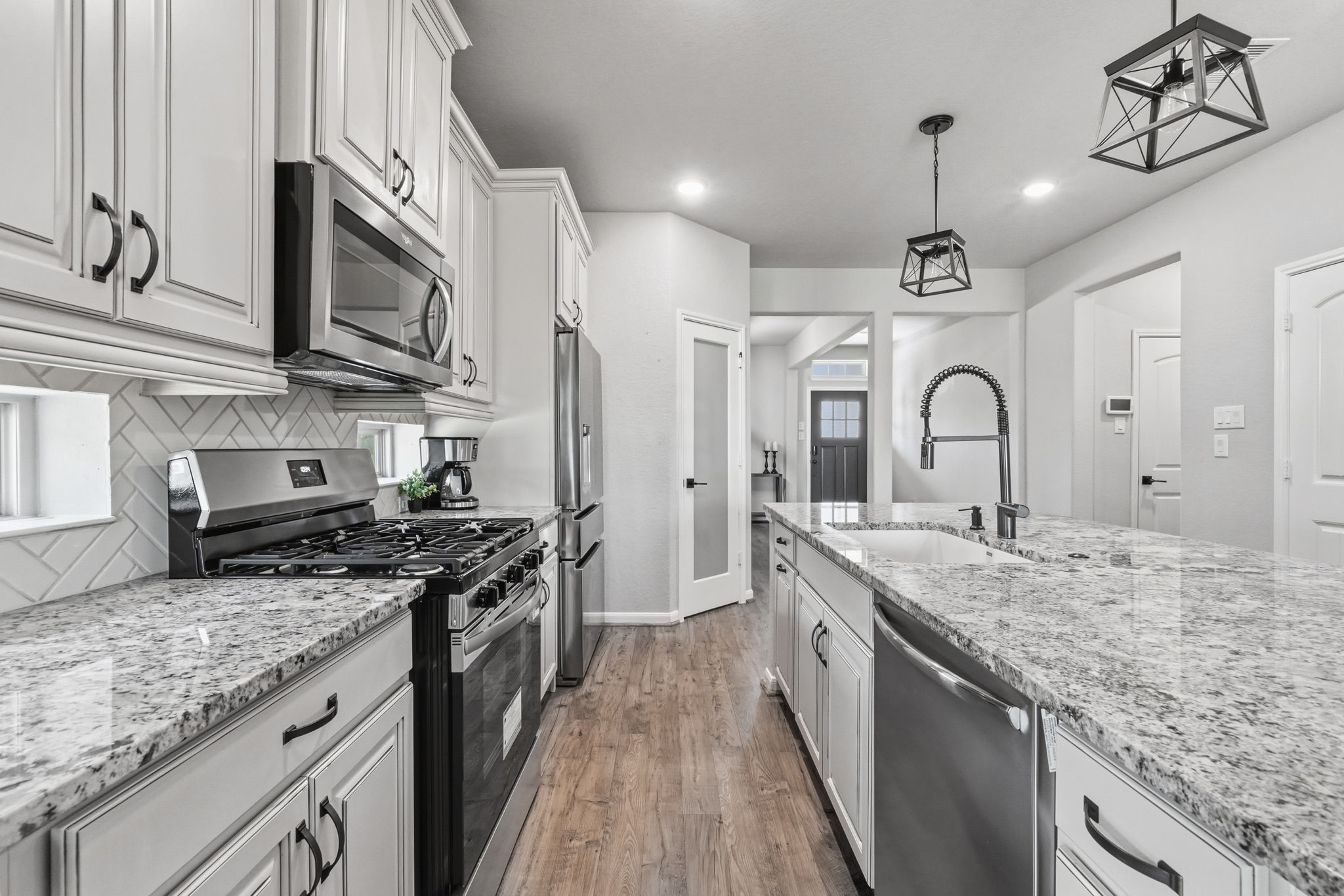 4334 Umber Shadow Drive Spring, TX 77386 - Photo 12 of 45 Beautiful kitchen offers extensive cabinetry, generous counter space, stainless steel appliances, and a clear sightline to the adjacent living areas.