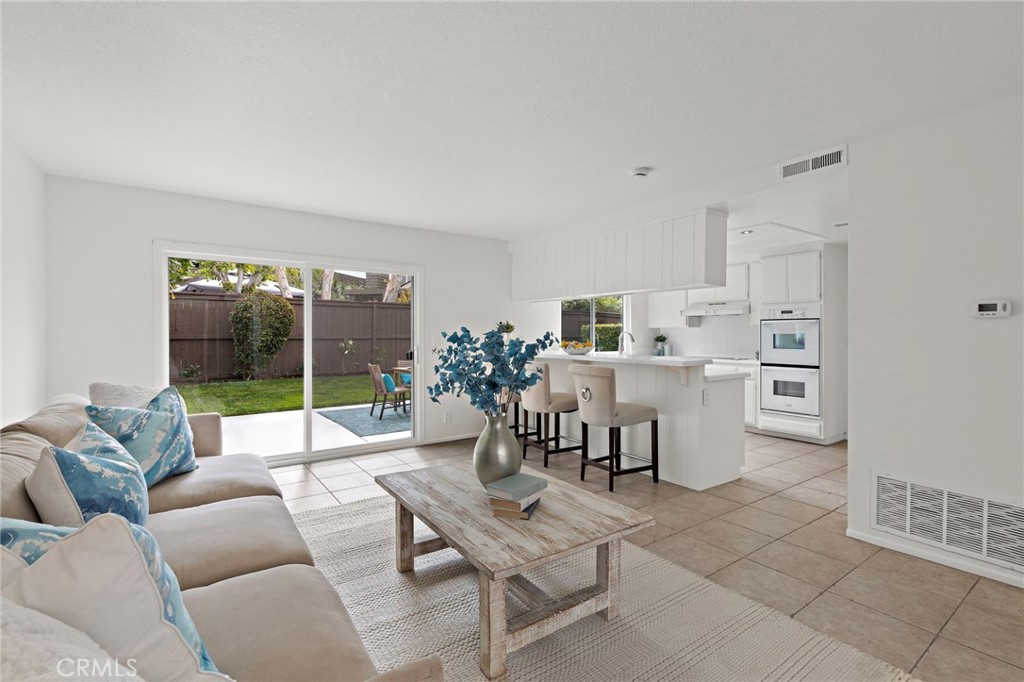 8 Caraway Irvine, CA 92604 - Photo 16 of 33 a living room with furniture and a large window