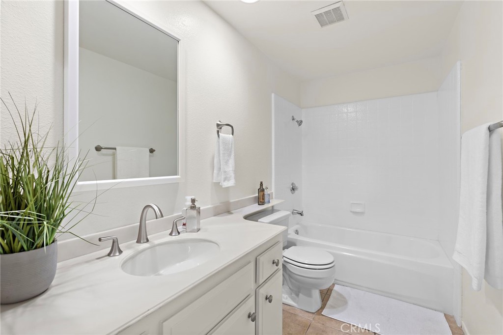 8 Caraway Irvine, CA 92604 - Photo 19 of 33 a bathroom with a granite countertop sink a toilet and a large mirror