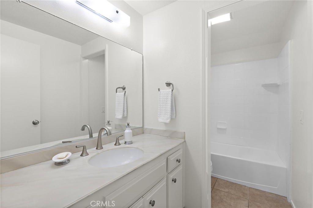 8 Caraway Irvine, CA 92604 - Photo 22 of 33 a bathroom with a tub sink and mirror