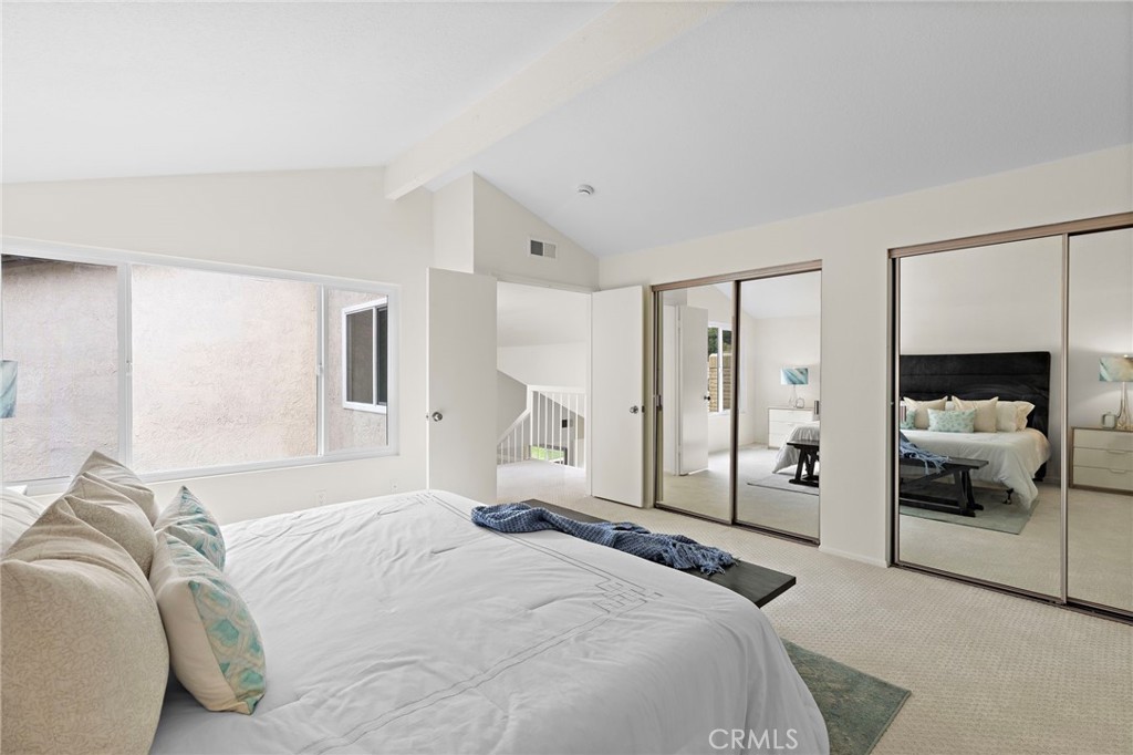 8 Caraway Irvine, CA 92604 - Photo 24 of 33 a bedroom with a bed and a large mirror