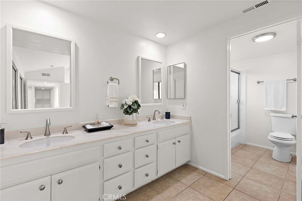 8 Caraway Irvine, CA 92604 - Photo 25 of 33 a spacious bathroom with a double vanity sink mirror and toilet