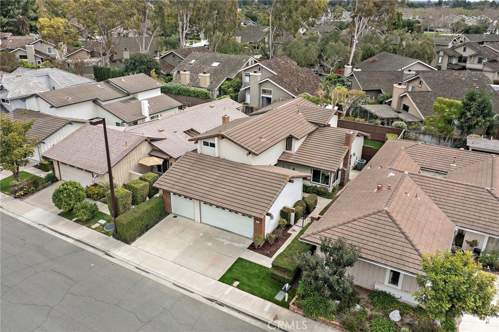 8 Caraway Irvine, CA 92604 - Photo 31 of 33 an aerial view of a house with a yard and parking spaces