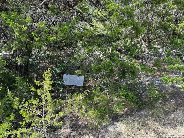 a backyard of a house with a yard and outdoor seating