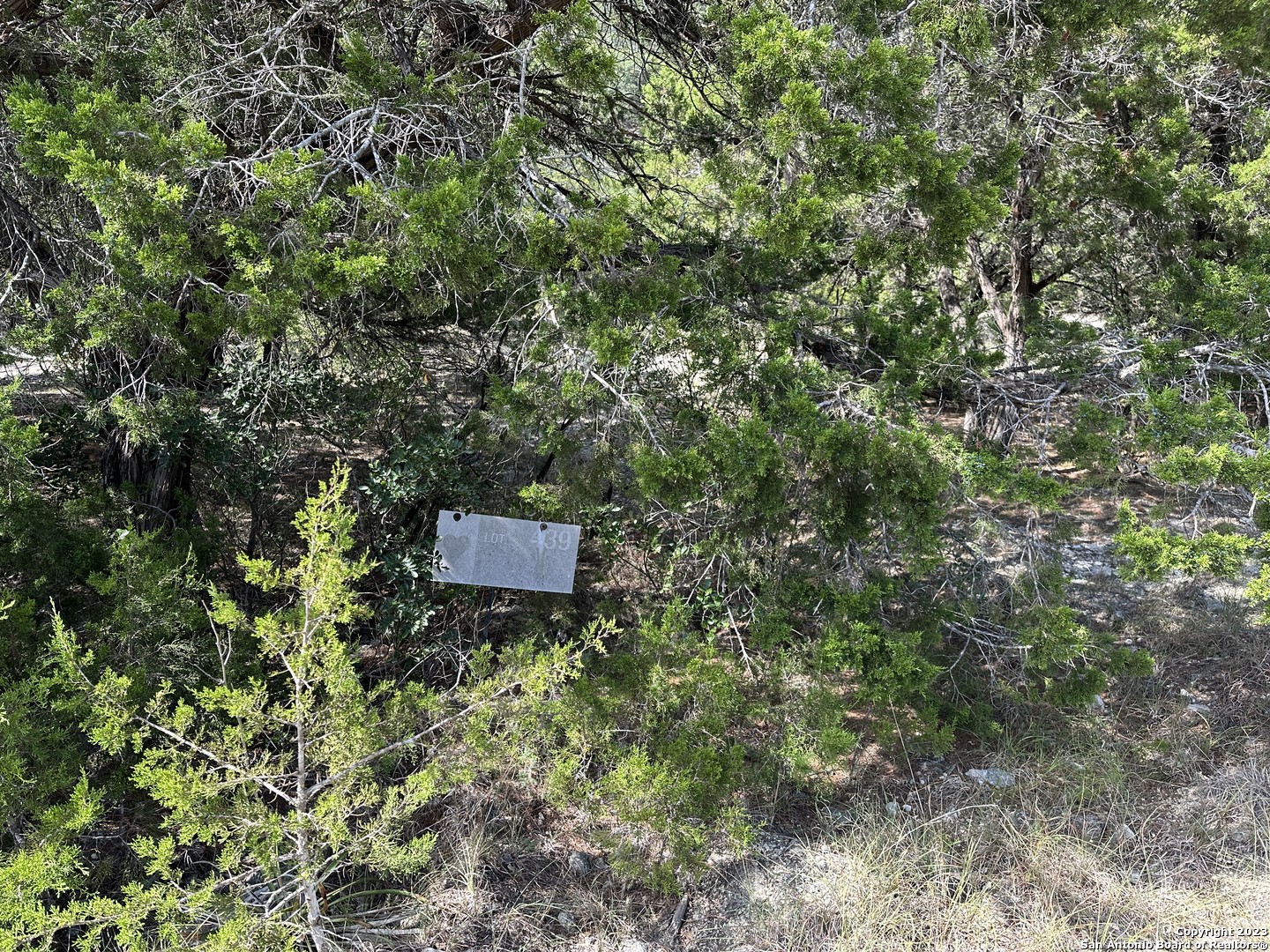 439 Private Road 180 Helotes, TX 78023 - Photo 9 of 15 a backyard of a house with a yard and outdoor seating
