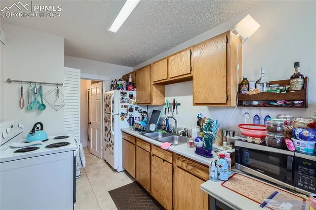 a kitchen with stainless steel appliances a stove a sink and a refrigerator