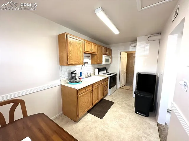 a living room with furniture and a ceiling fan