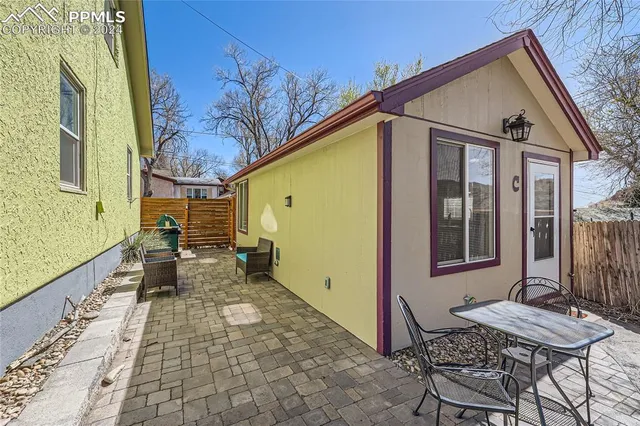 a view of a patio with a table and chairs