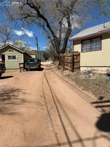 a view of a house with snow on the road