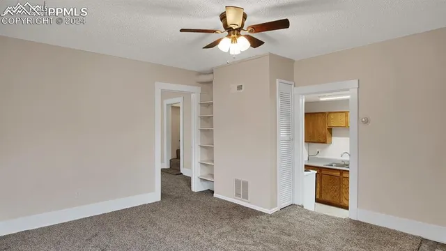 a view of a room with a hallway and a chandelier
