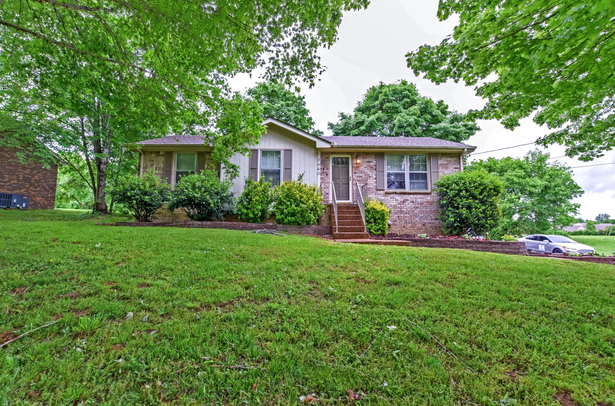 2860 South Rutland Road Mount Juliet, TN 37122 - Photo 1 of 20 a view of a house with yard and a garden