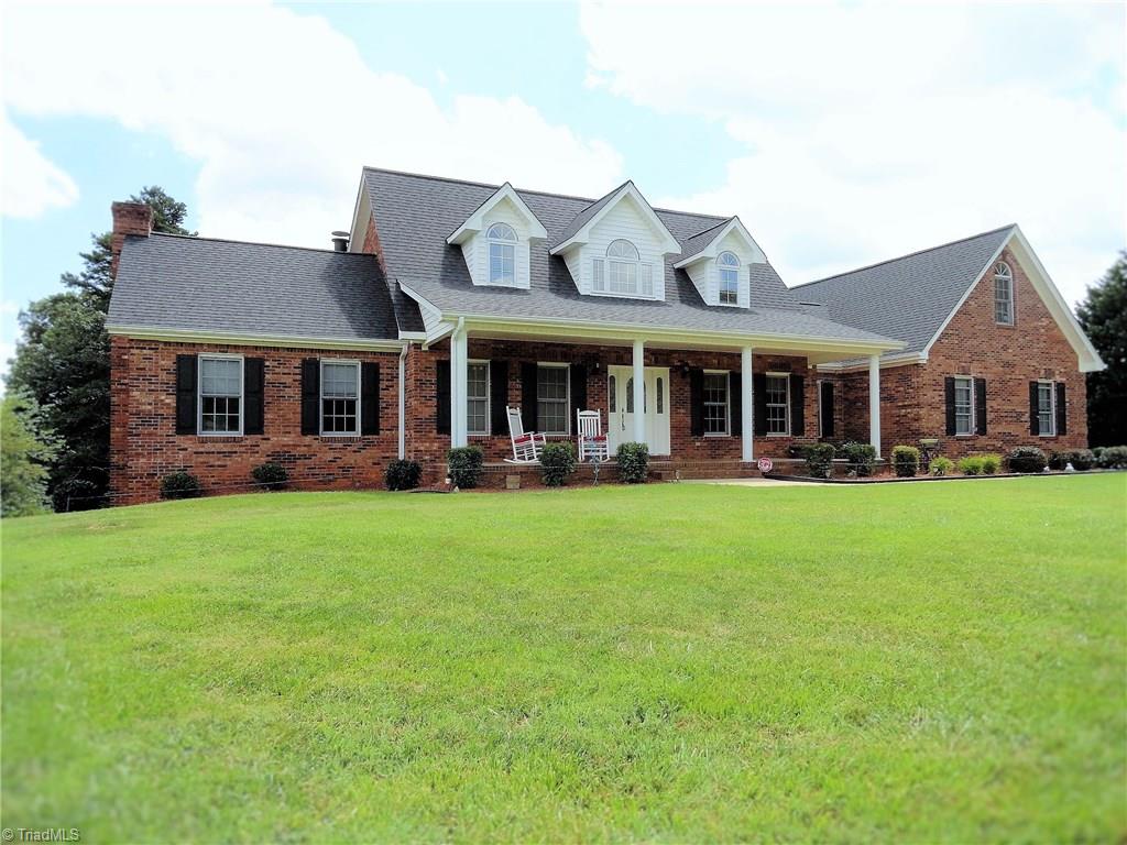 1122 Nance Road King, NC 27021 - Photo 1 of 30 4 BR/ 4.2 baths with 9 ft. ceilings, hardwoods on main level, finished basement with game room, guest room/office, workshop...so much space for everyone! Great wooded views from sunroom, pasture and creek on the property