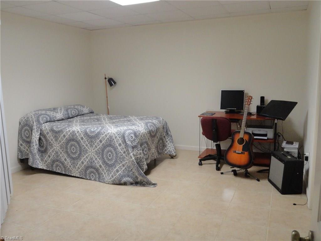 1122 Nance Road King, NC 27021 - Photo 20 of 30 This lower level space just off the game room functions as extra guest space, and was previously a music room. The recording studio is currently being used as closet space