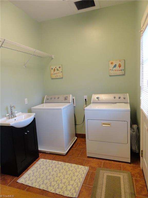 1122 Nance Road King, NC 27021 - Photo 23 of 30 Laundry room has clean-up sink and overhead hamper from upstairs bedrooms makes for easy clean-up. Quick access to backyard deck.