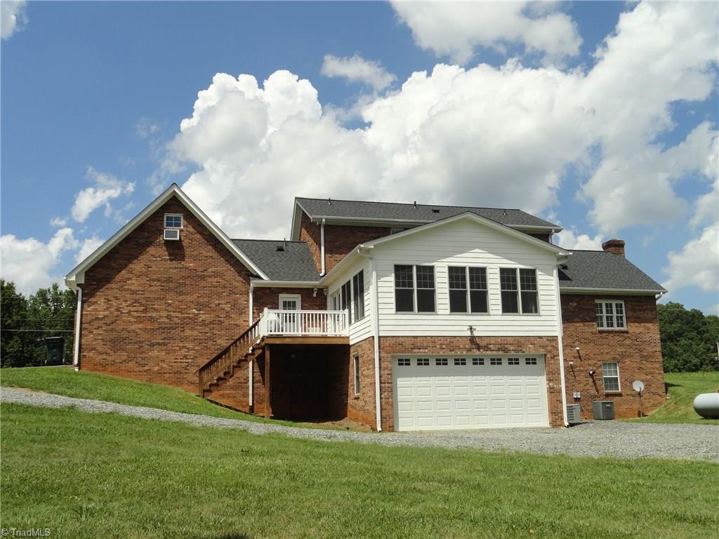 1122 Nance Road King, NC 27021 - Photo 26 of 30 Back of home - 2 car attached garage on main level, huge basement workshop for additional equipment storage