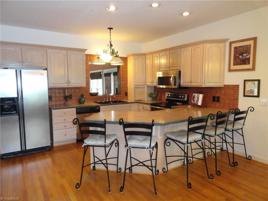 1122 Nance Road King, NC 27021 - Photo 5 of 30 Kitchen has hardwoods, great storage, and spacious eat at bar.
