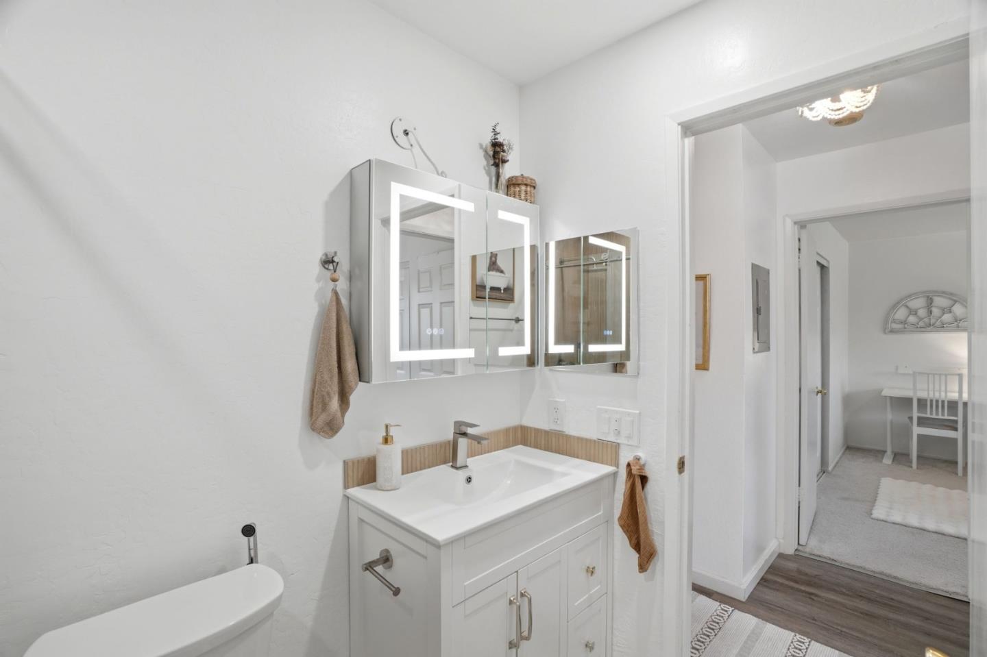 2025 California Street, Unit 40 Mountain View, CA 94040 - Photo 19 of 31 a bathroom with a toilet a sink a mirror and a shower
