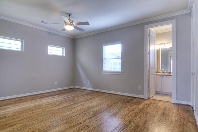 1138 Robbie Street Houston, TX 77009 - Photo 12 of 17 a view of an empty room with wooden floor and a window