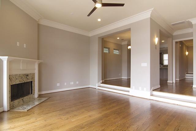 1138 Robbie Street Houston, TX 77009 - Photo 3 of 17 an empty room with wooden floor and fireplace